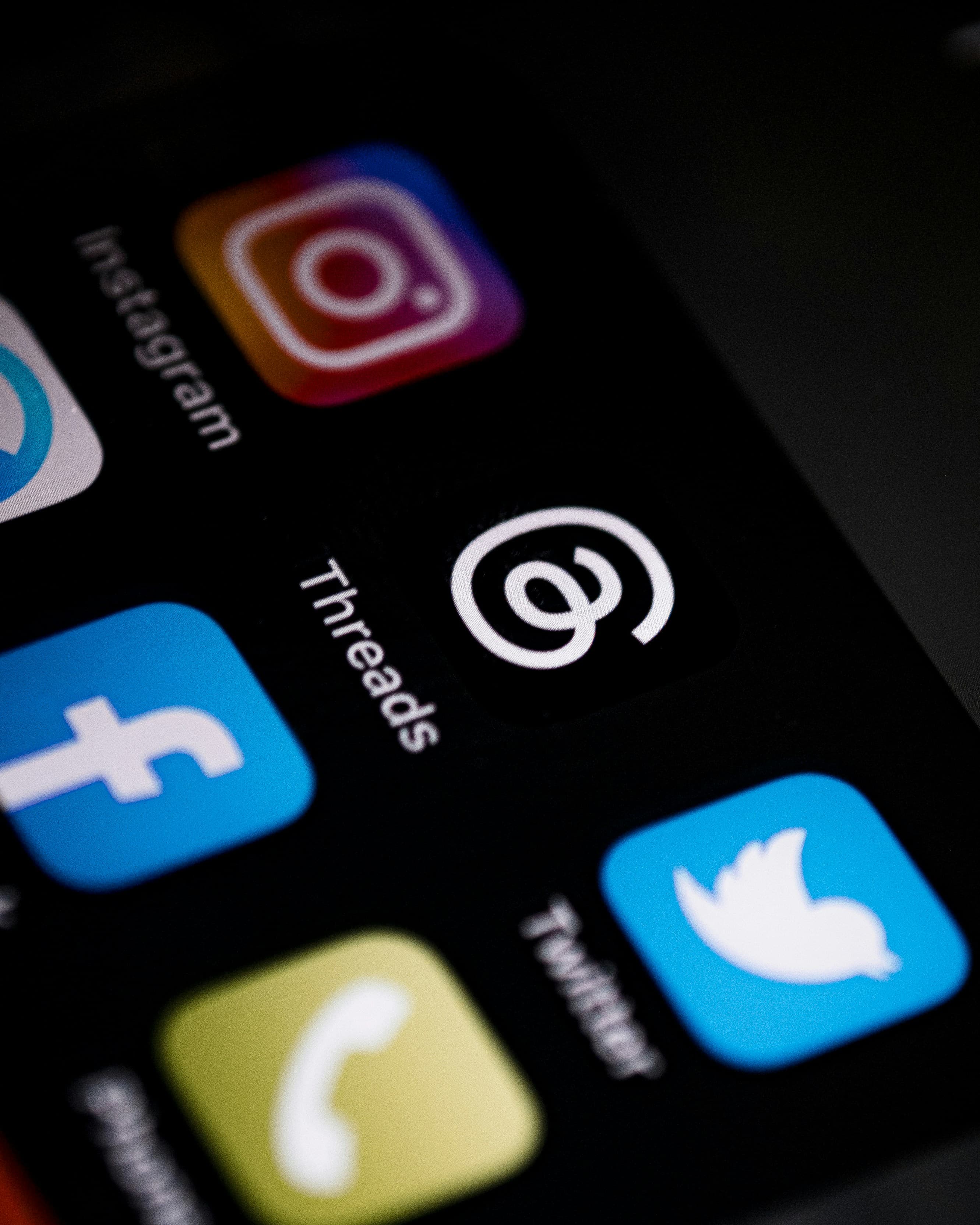 Phone screen showing Instagram, Threads, and Facebook