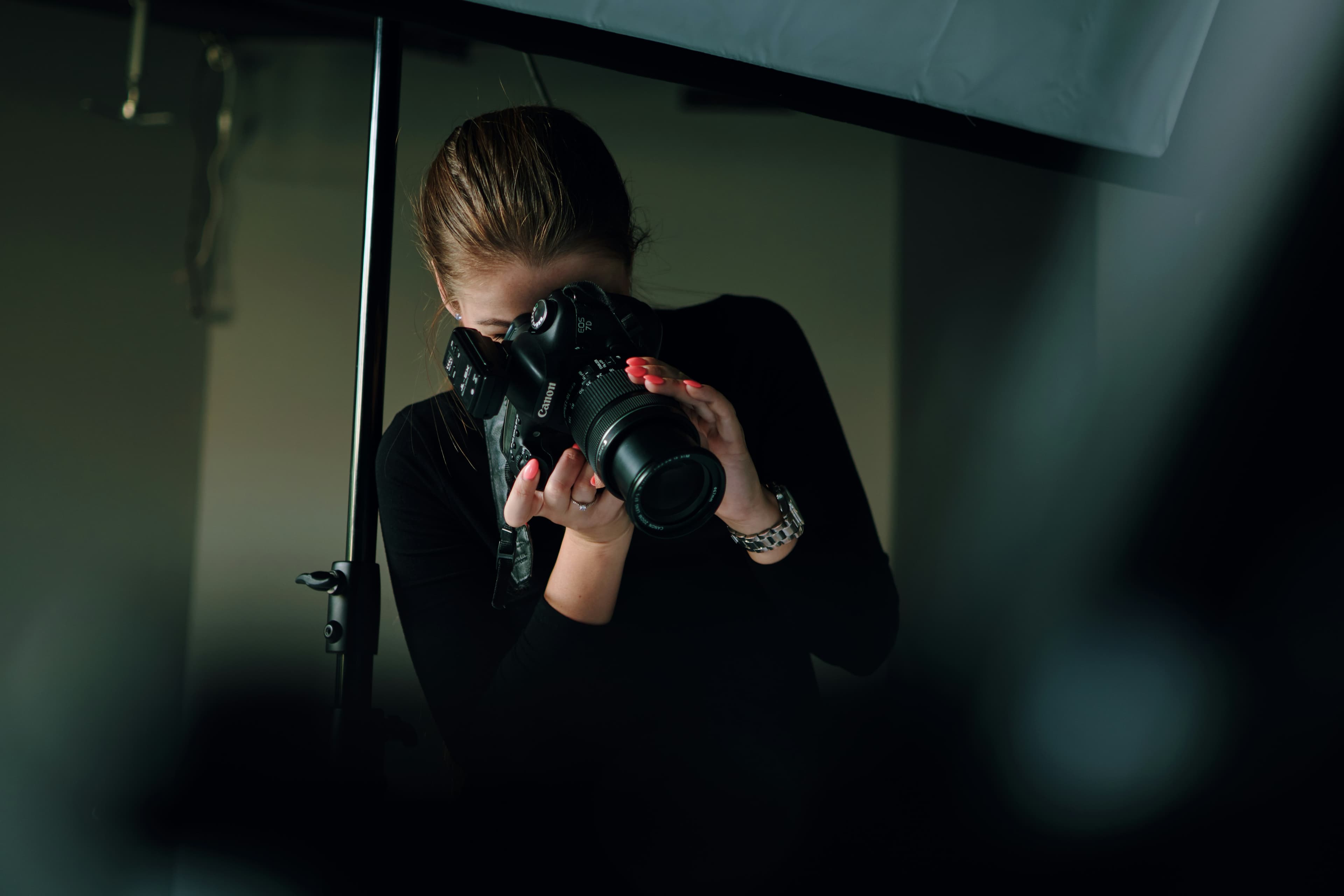 Photographer framing a shot under studio light